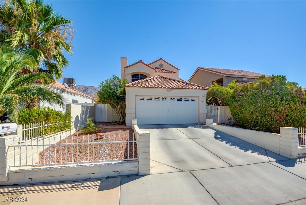 mediterranean / spanish-style home with a garage