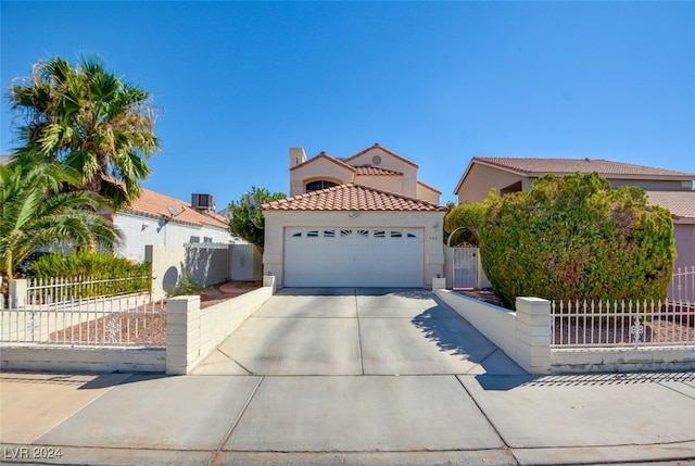 mediterranean / spanish house with a garage