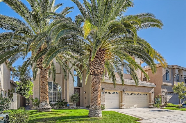 view of front facade featuring a front yard and a garage