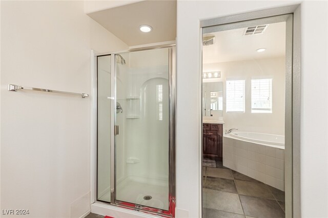 bathroom featuring plus walk in shower, tile patterned floors, and vanity