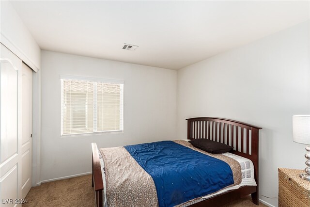 carpeted bedroom featuring a closet