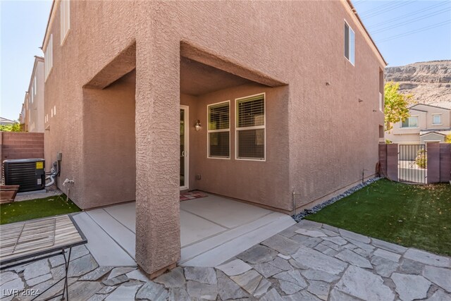 rear view of house with a patio and central air condition unit