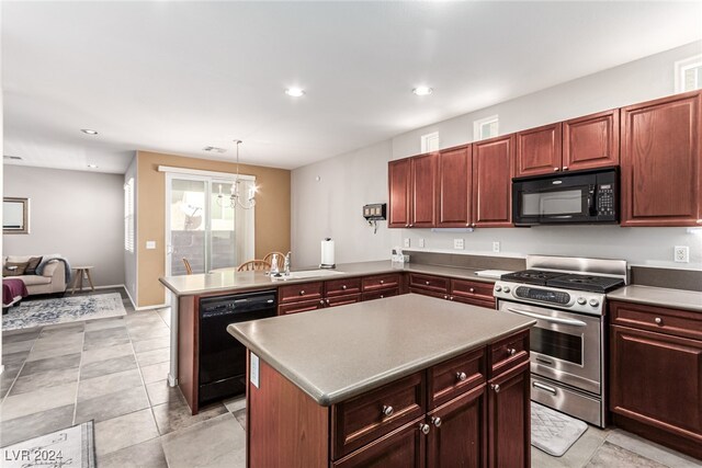 kitchen featuring pendant lighting, black appliances, kitchen peninsula, and a kitchen island