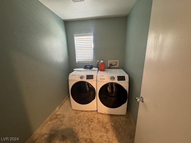 clothes washing area with washing machine and dryer