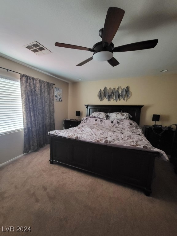 bedroom with ceiling fan and carpet