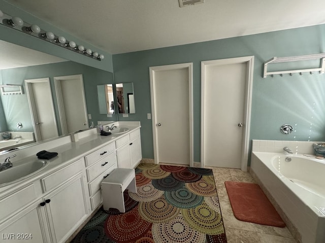 bathroom featuring vanity, tile patterned floors, and a relaxing tiled tub