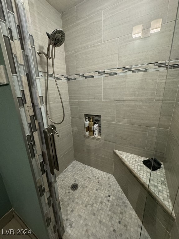 bathroom with a shower with door