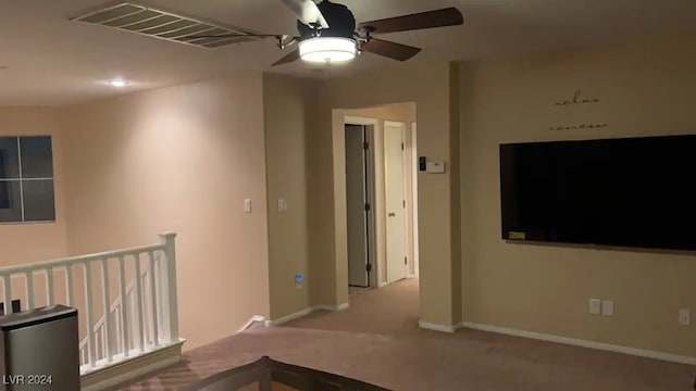 empty room featuring light carpet and ceiling fan