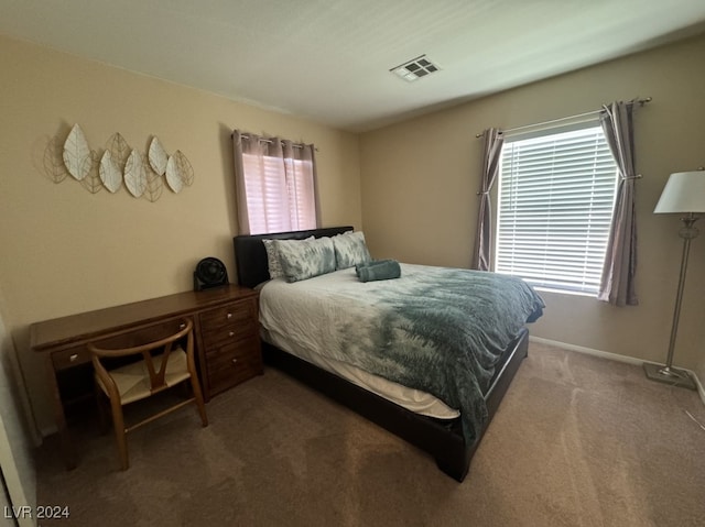 bedroom with multiple windows and carpet flooring