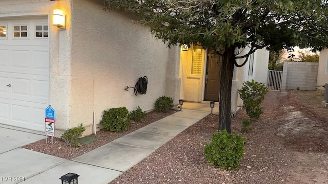 doorway to property with a garage