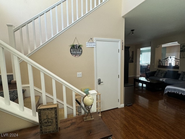 stairs featuring hardwood / wood-style floors