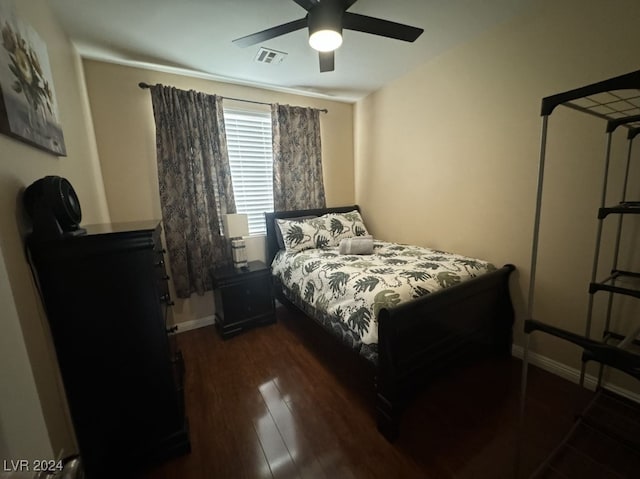 bedroom with dark wood-type flooring and ceiling fan