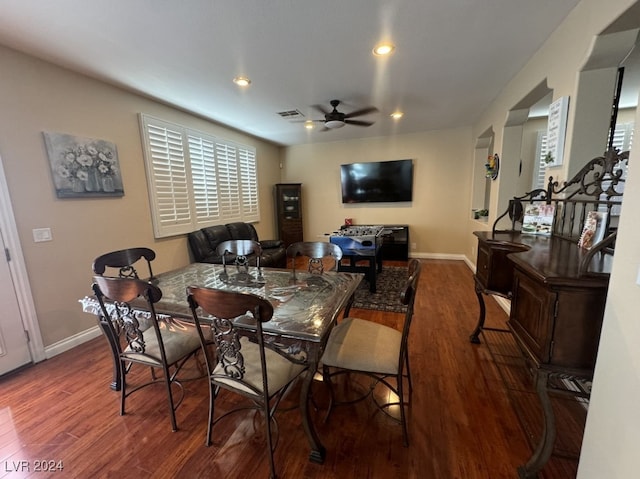 dining space with ceiling fan and dark hardwood / wood-style flooring