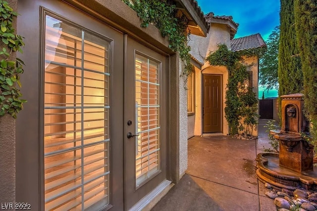 exterior entry at dusk with a patio