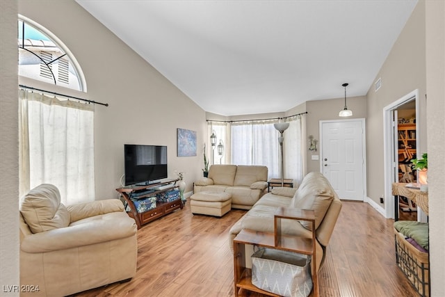 living room with lofted ceiling and light hardwood / wood-style floors