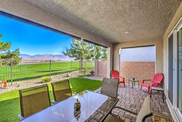 view of patio / terrace with a mountain view