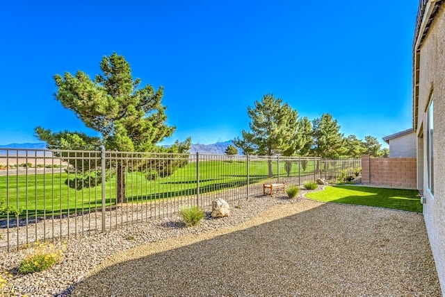 view of yard with a fenced backyard and a mountain view