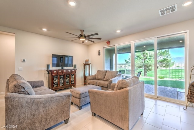 living room with light tile patterned flooring, ceiling fan, visible vents, and recessed lighting