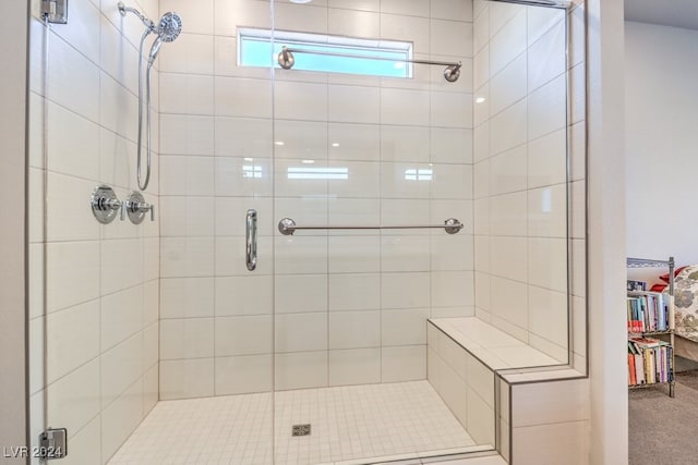 full bathroom featuring a walk in closet and a shower stall