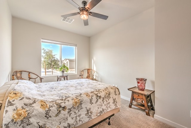 bedroom featuring light carpet, ceiling fan, visible vents, and baseboards