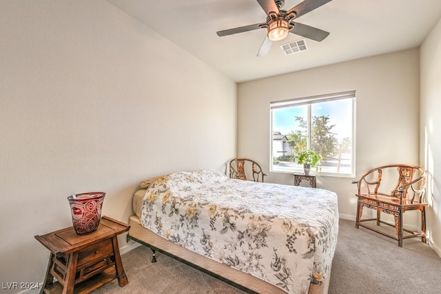 carpeted bedroom featuring ceiling fan, visible vents, and baseboards