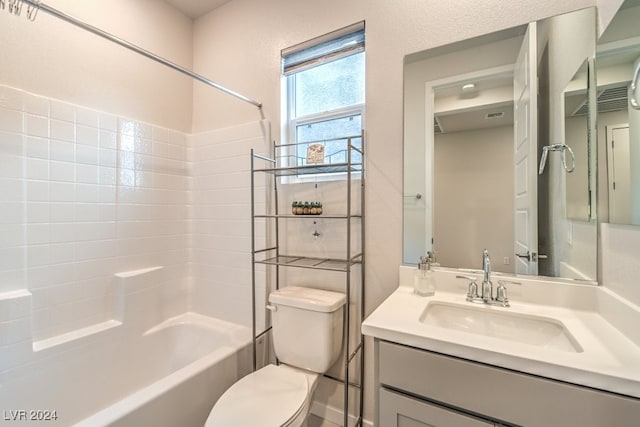 bathroom featuring shower / bath combination, vanity, and toilet