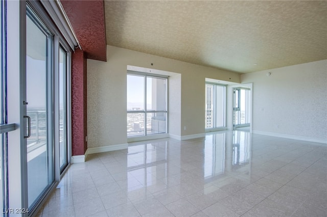 unfurnished room with a textured ceiling