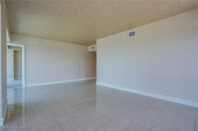 spare room featuring a textured ceiling