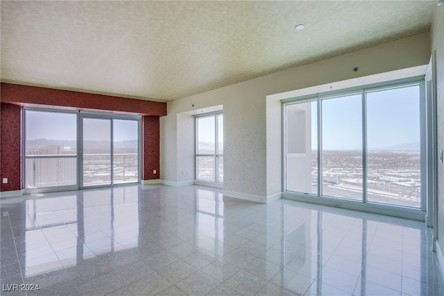 unfurnished room featuring a textured ceiling