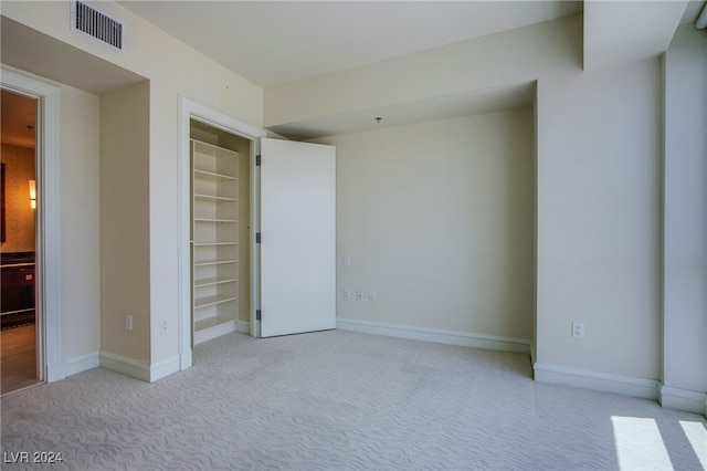 unfurnished bedroom featuring light colored carpet