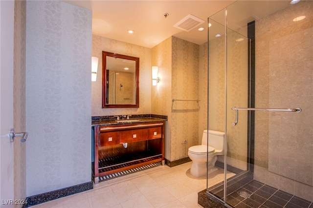 bathroom featuring vanity, toilet, and an enclosed shower