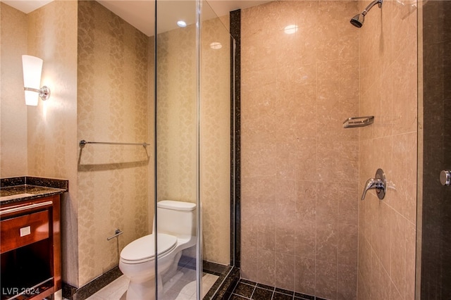 bathroom with vanity, tile patterned flooring, toilet, and a shower with door