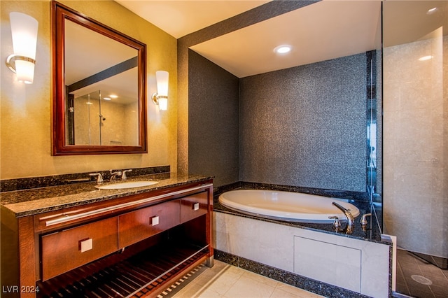 bathroom with shower with separate bathtub, vanity, and tile patterned floors