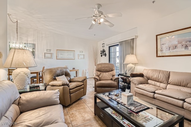 living room with ceiling fan with notable chandelier and light tile patterned floors