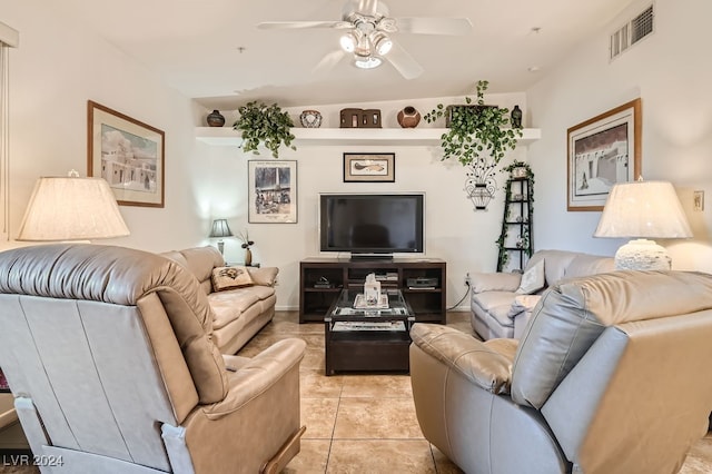 living room featuring ceiling fan, lofted ceiling, and light tile patterned floors