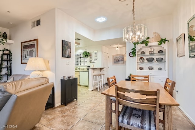 dining room with light tile patterned floors and a chandelier