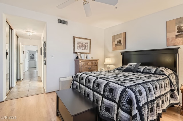 bedroom with light hardwood / wood-style floors and ceiling fan