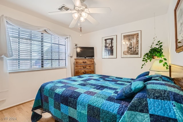 bedroom with hardwood / wood-style floors and ceiling fan