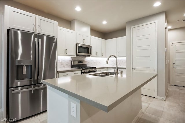 kitchen featuring sink, white cabinetry, a kitchen island with sink, and appliances with stainless steel finishes