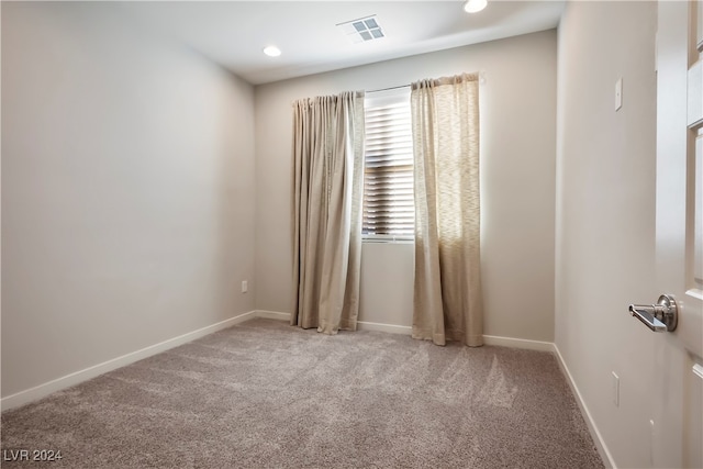 spare room with light colored carpet