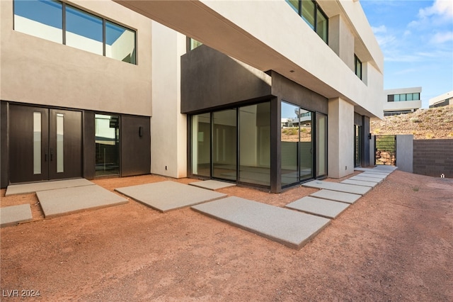 back of property with a patio and french doors