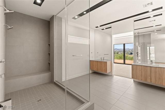 bathroom featuring vanity, walk in shower, and tile patterned floors