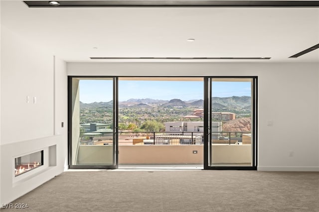 carpeted spare room featuring a mountain view