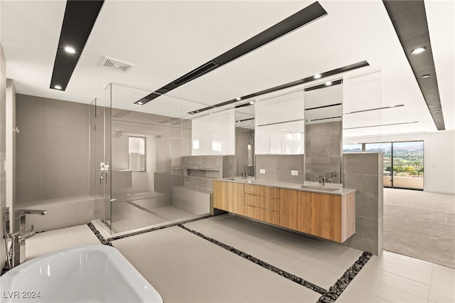 bathroom featuring vanity, shower with separate bathtub, tile patterned floors, and tile walls