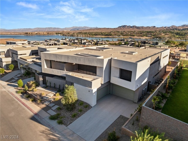 aerial view featuring a water and mountain view