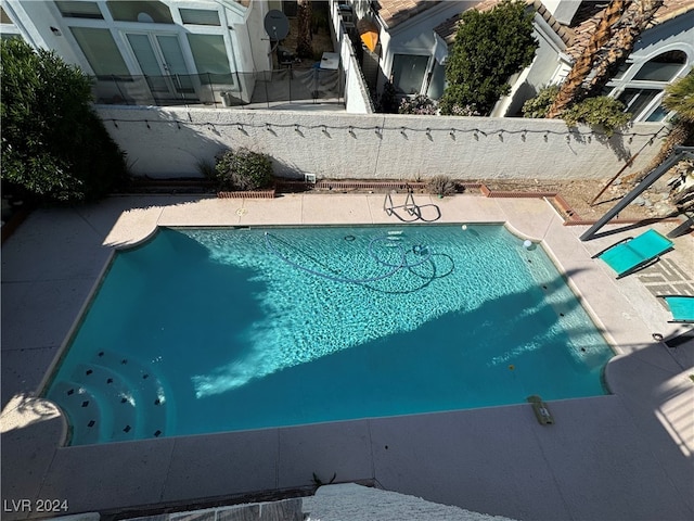 view of swimming pool with a patio area