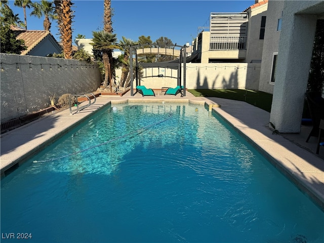 view of swimming pool featuring a patio and a pergola