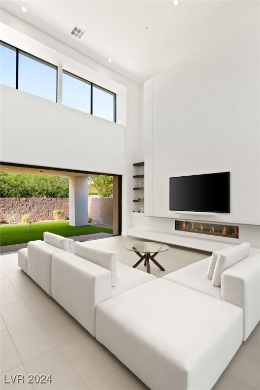 tiled living room with a high ceiling