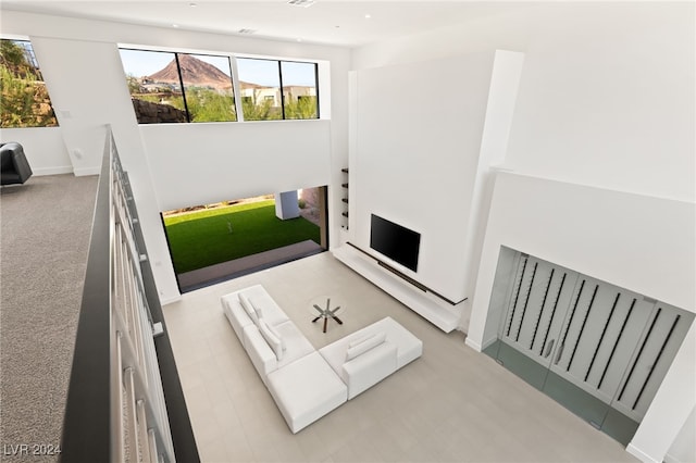 carpeted living room featuring a mountain view