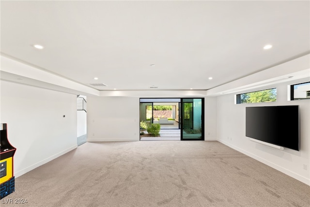 unfurnished living room featuring light colored carpet